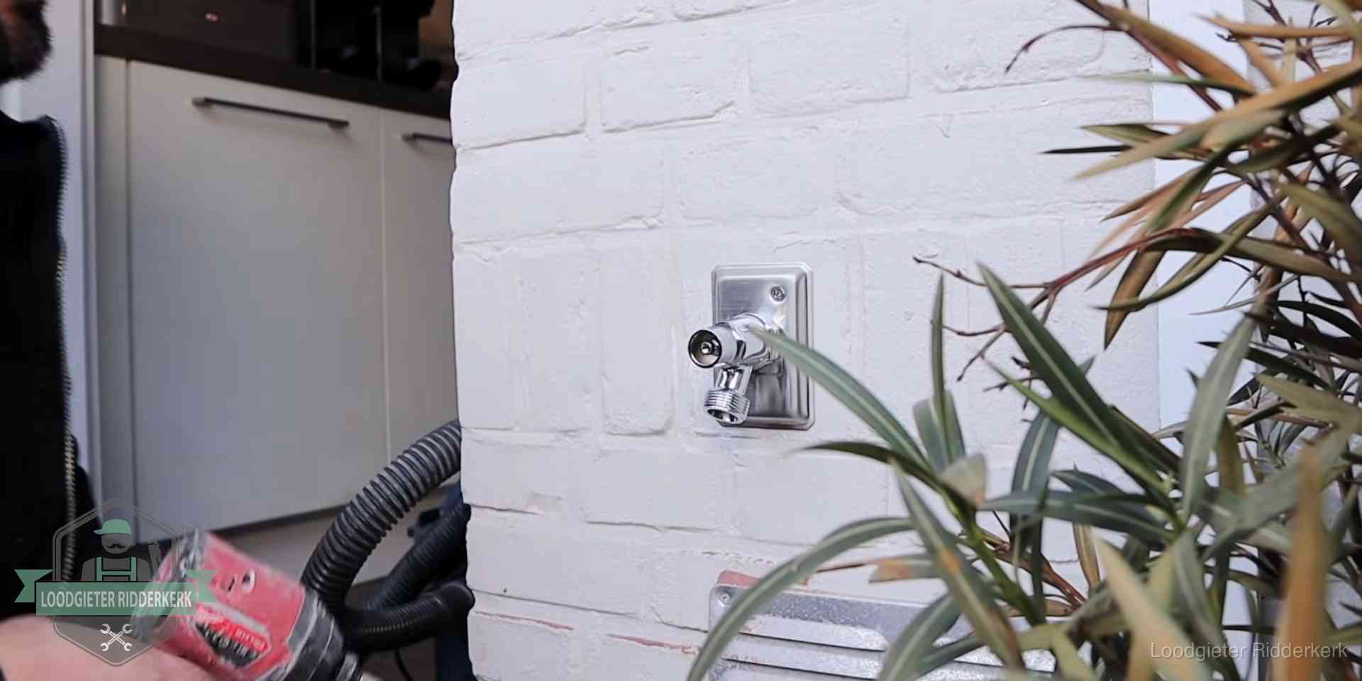 Chromen kraan op een muurplaat bij een woning in Ridderkerk, dichtdraaien is stap een van de lektest
