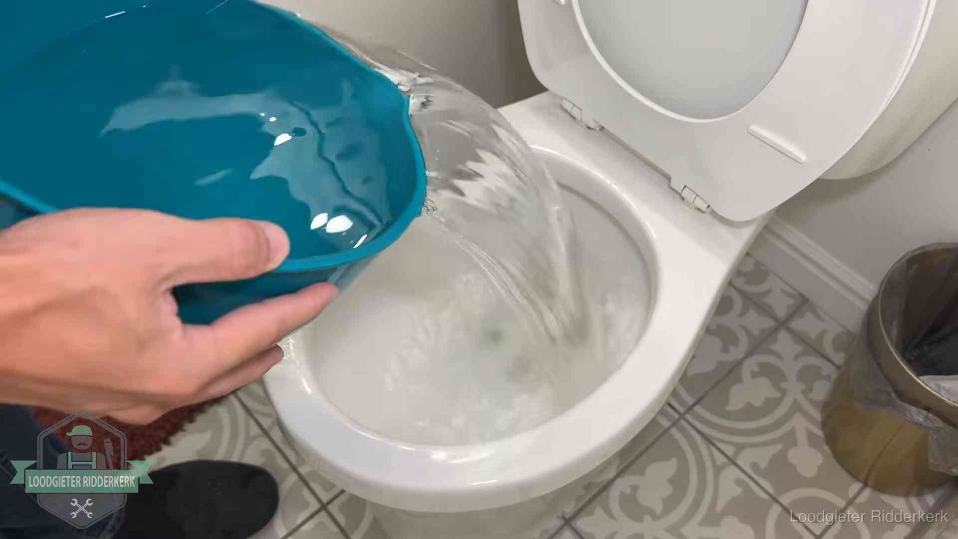 Warm water wordt voorzichtig in de wc-pot gegoten in Ridderkerk